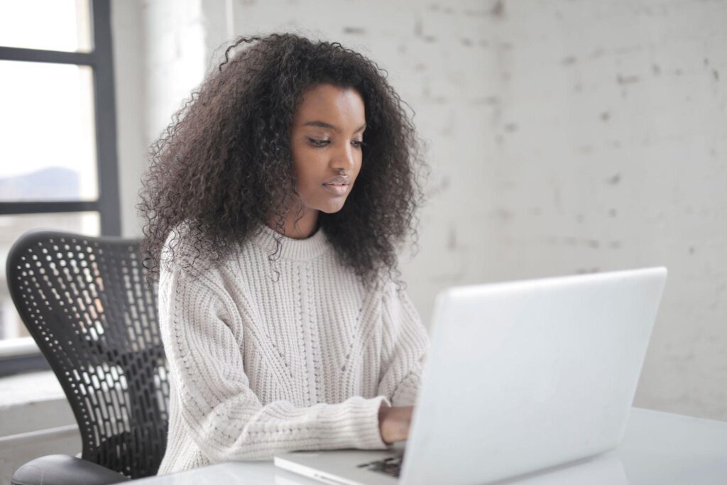 Photo Of a Black Woman Using Laptop
