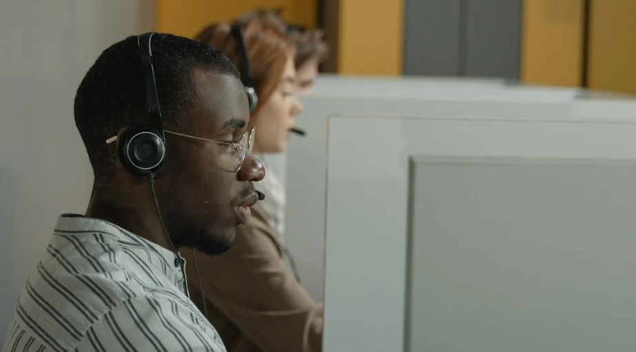 A Man in White and Black Stripe Shirt Wearing Black Headphones
