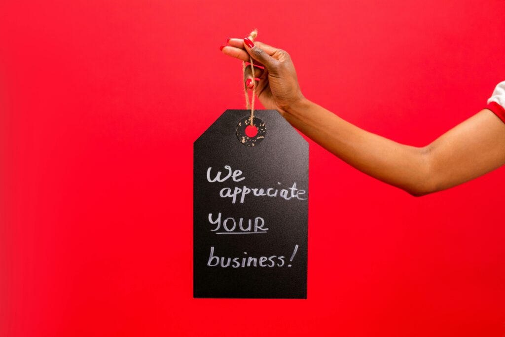Person Holding a Chalkboard with a Text Saying "We Appreciate Your Business"